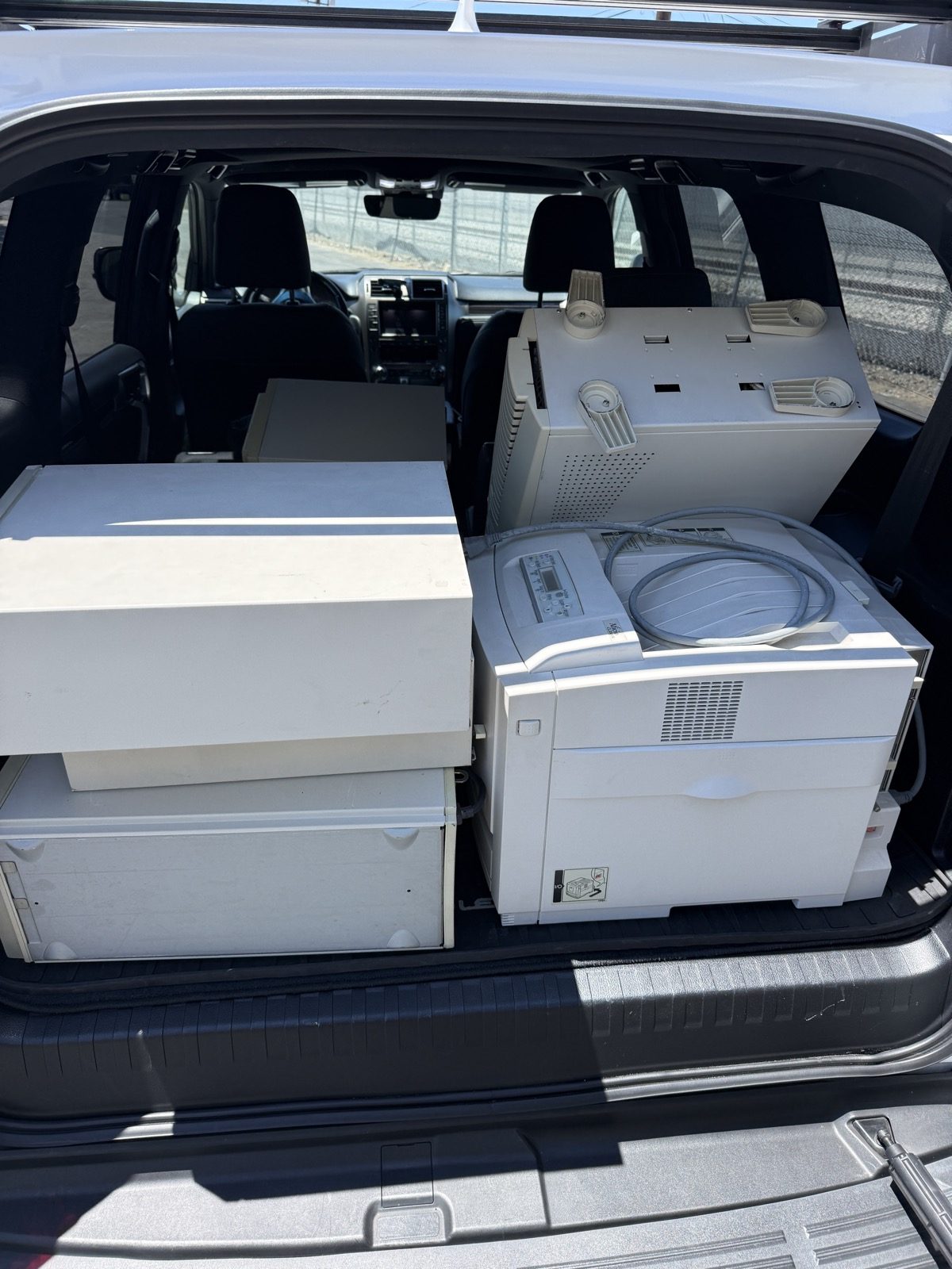 Stacked business desktop computers ready for e-waste pickup